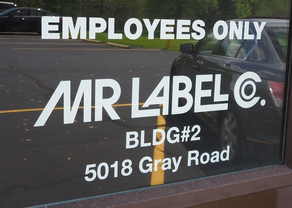 Vinyl diecut lettering on a glass entry door.