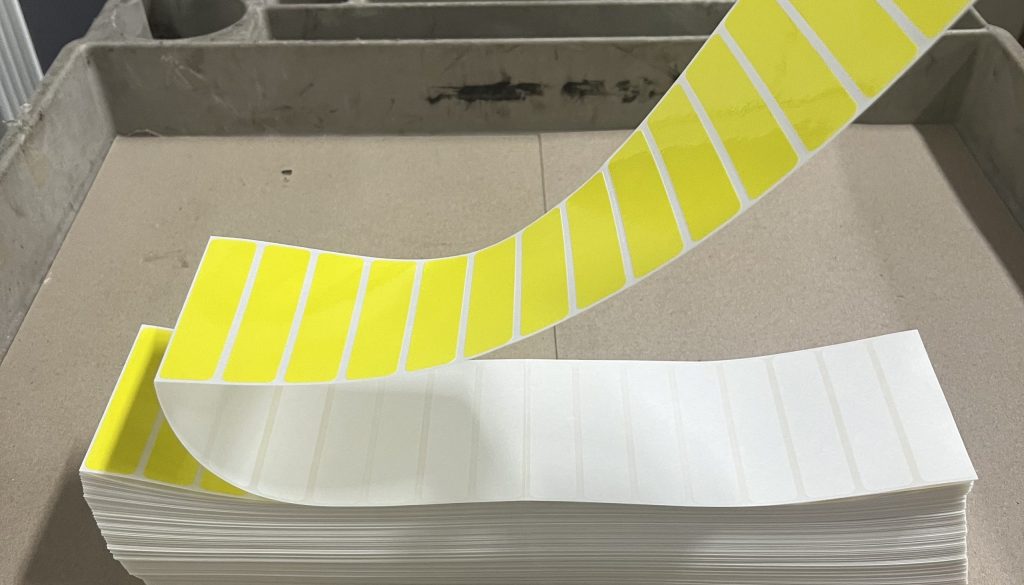 Sheet of perforated labels arranged in a uniform grid with clean tear lines.