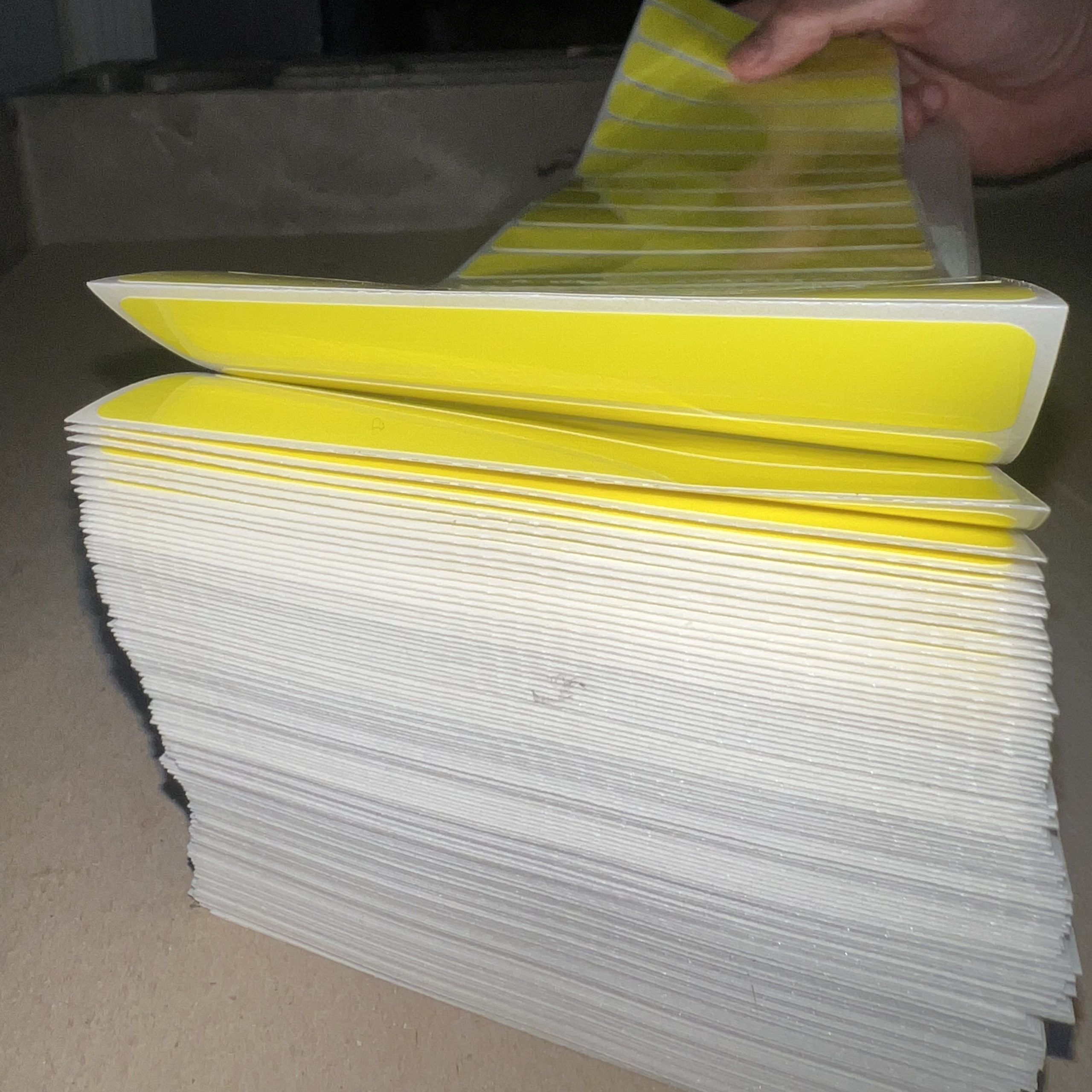 Sheet of perforated white labels arranged in a uniform grid with clean tear lines.